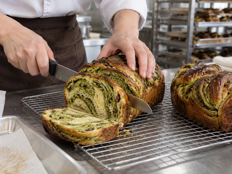 Baked matcha babka slice inspected for crumb and swirl