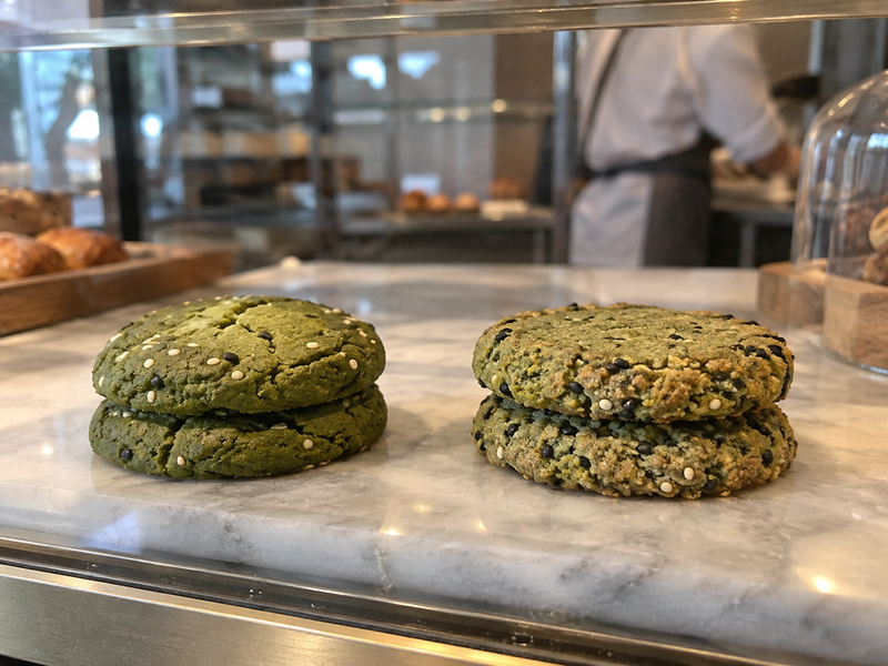 Measured matcha cookie portions are spaced on a bakery sheet pan