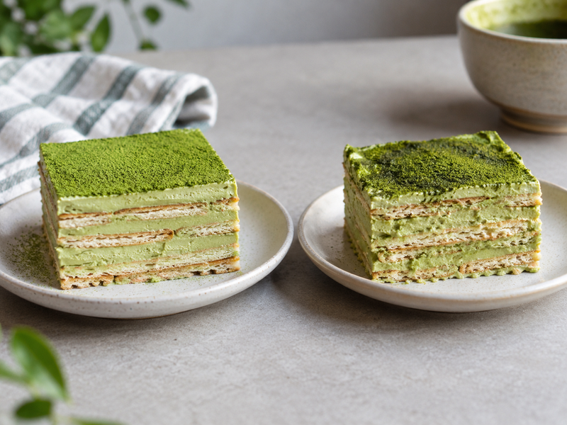 Overhead view of measured strawberry slices arranged evenly over matcha cream