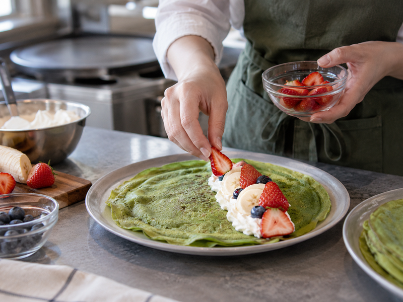 Matcha crepe filled to order with measured fruit and cream