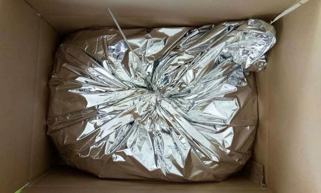 Silver foil inner bag packed inside an open bulk carton