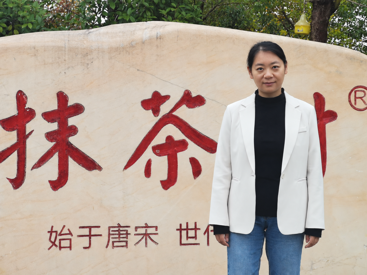 Laura Zhang standing in a white jacket