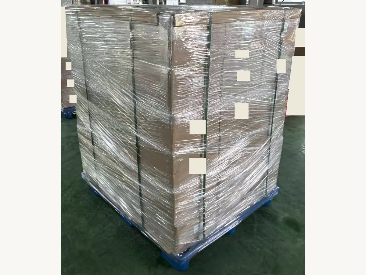Matcha cartons strapped and wrapped on a pallet, with labels redacted