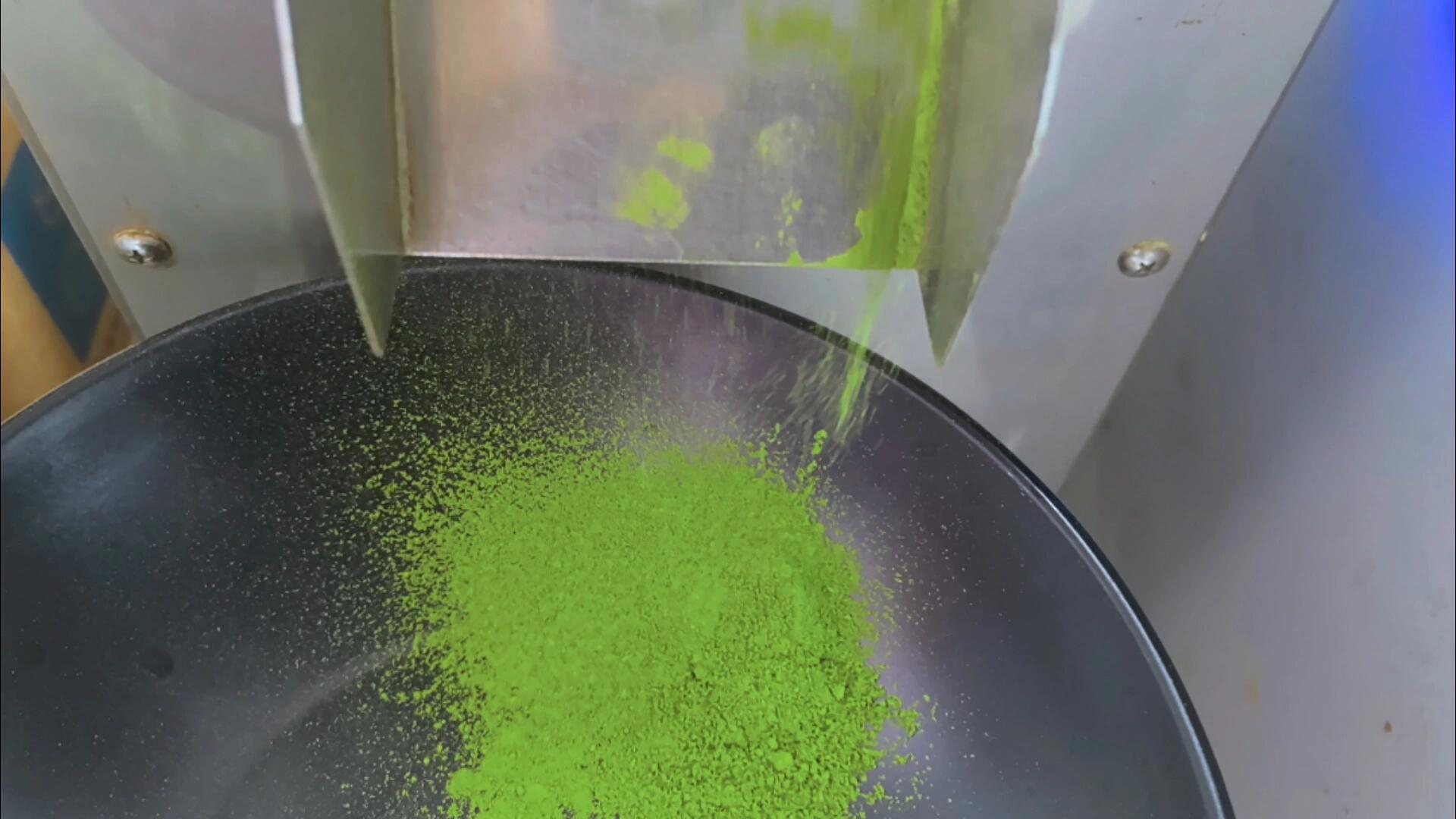 Matcha powder leaving a milling machine into a collection tray