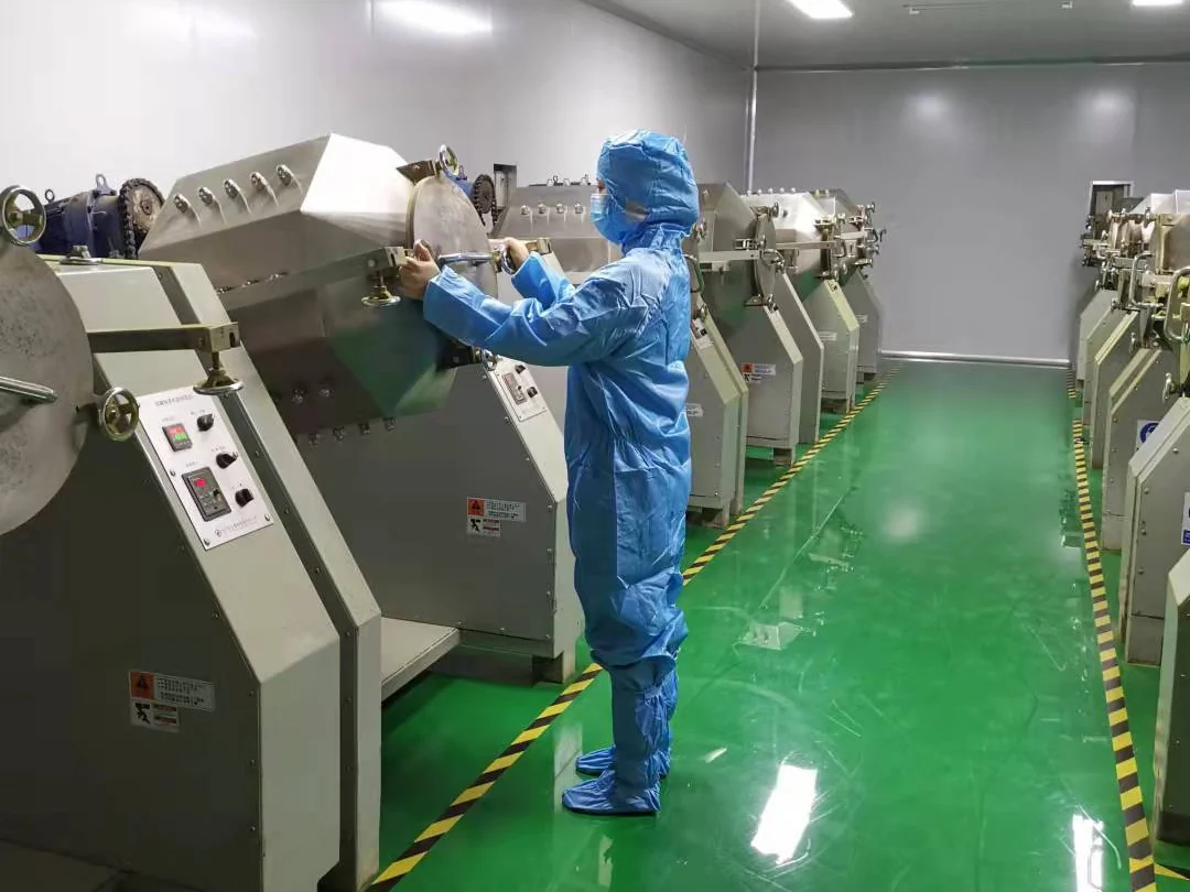 Production operator checking matcha processing equipment in the factory