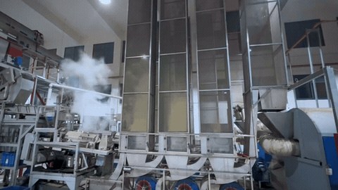 Steam rising around tea processing equipment
